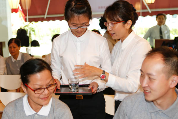 During the role-play session of the training class, some trainees took on the role of customers while others, the role of the book café workers. Photo by Huang Da Lun