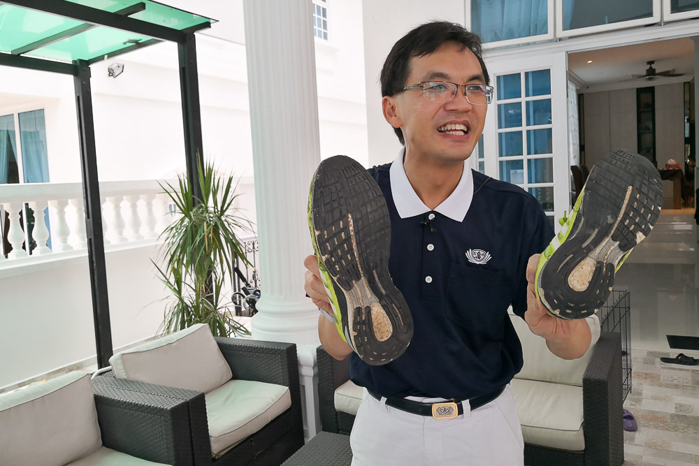 Dr. Ho showing us a pair of his old sports shoes which he is still wearing after 5 years. (Photo by Wong Twee Hee) 